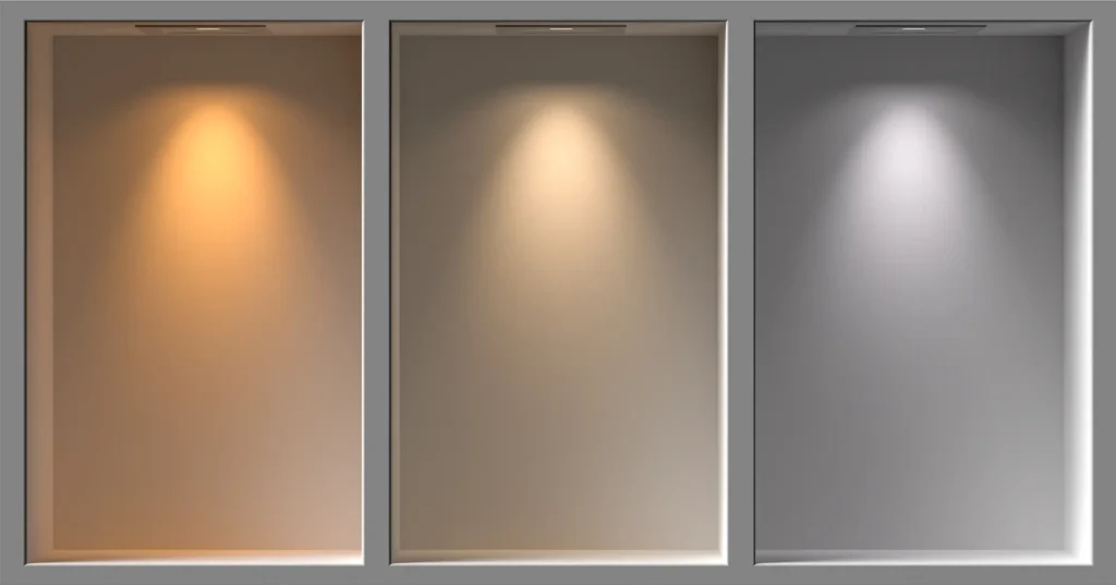 Three recessed wall niches illuminated with warm, neutral, and cool lighting tones to showcase different ambience effects