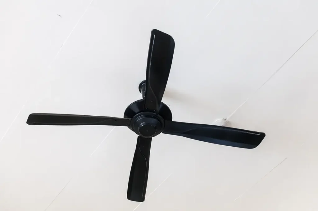 Black 3-blade mini ceiling fan mounted on white ceiling